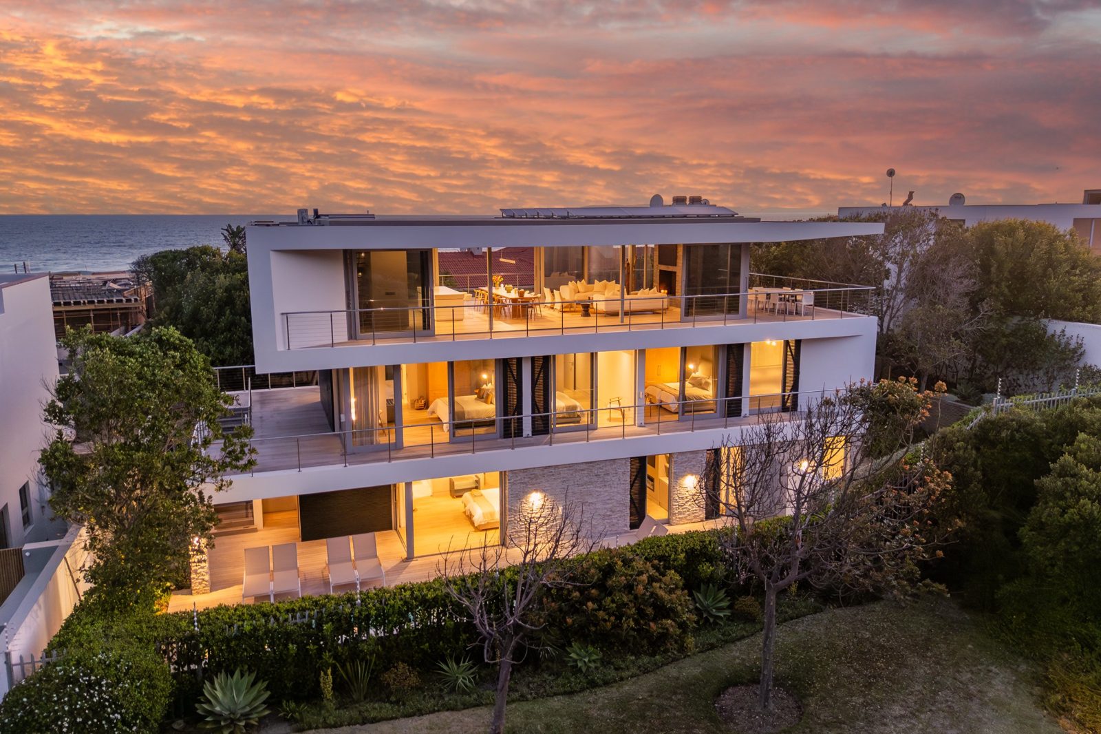Aerial twilight view of a three-storey coastal home