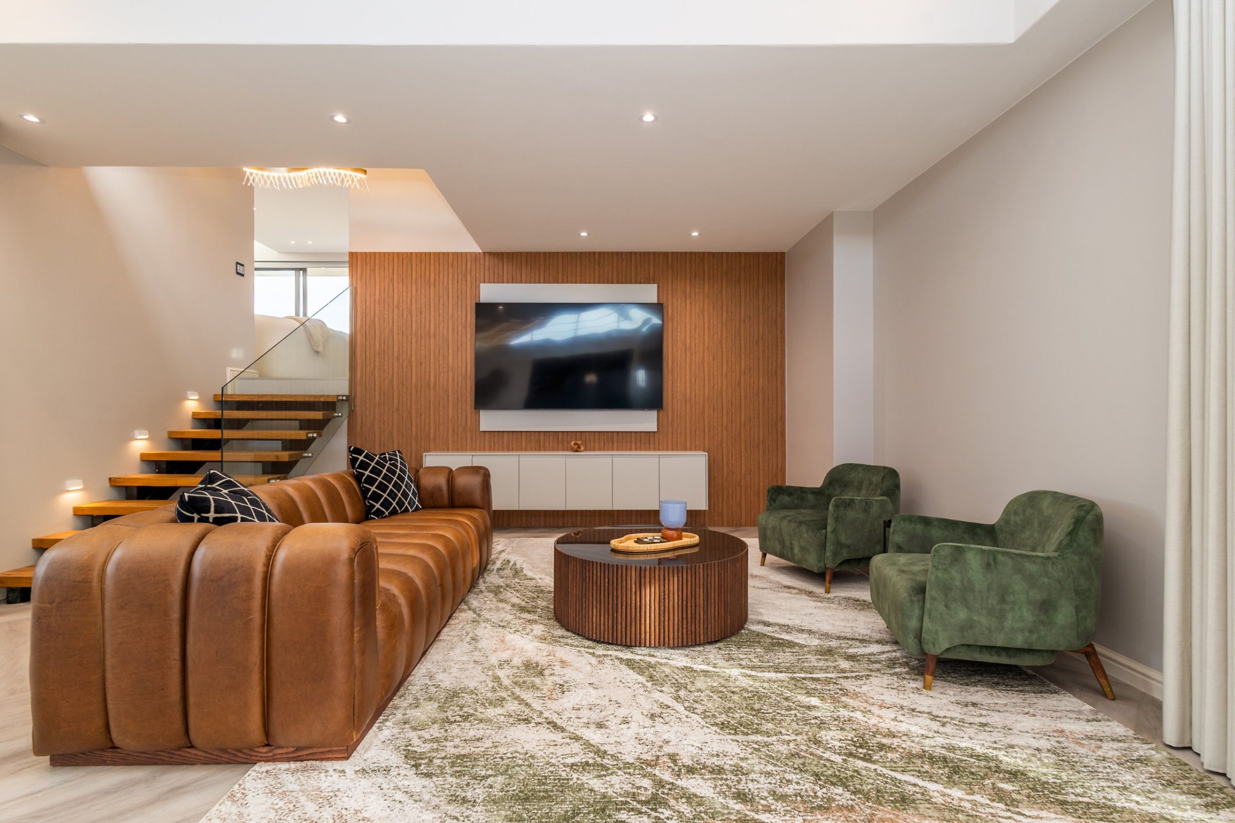 Living room with a leather sofa and timber feature wall